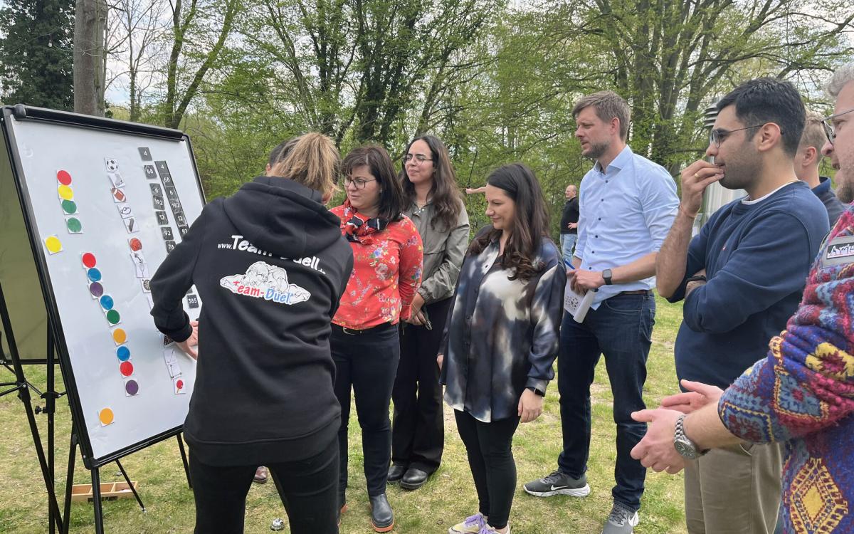 people standing around a board playing a game