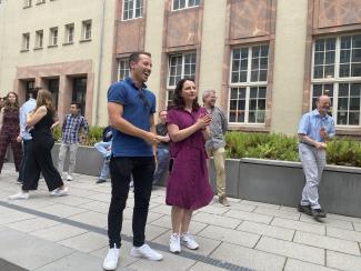 people standing outside a building, laughing and having fun