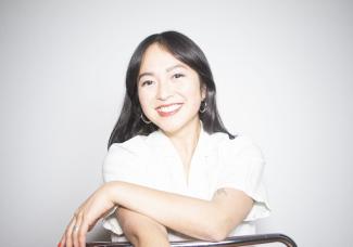 young woman with black hair smiling