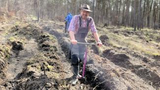 man with shovel on acre